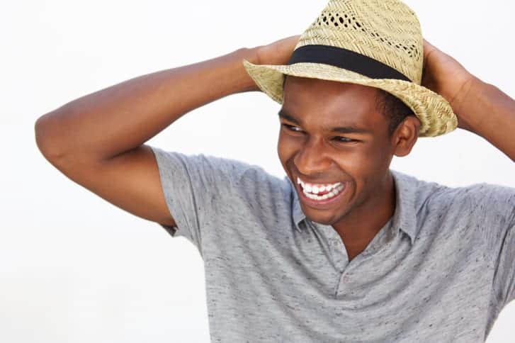 Carefree african american man smiling with hat